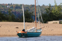 Beached shallow draft sailboat